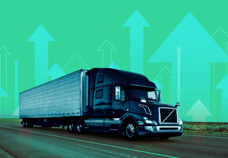 A circuit-patterned truck tire breaks through ice, symbolizing AI demand ending trucking’s freight recession.