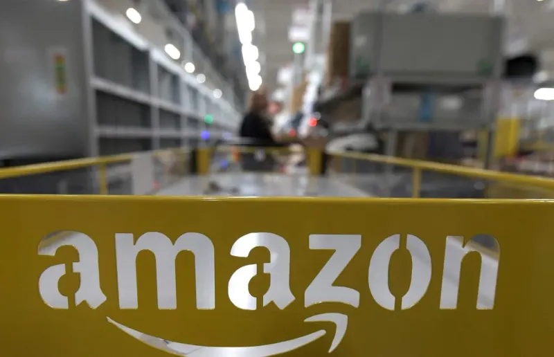 A golden river splits into two towering waterfalls, symbolizing Amazon's dual trillion-dollar revenue ambition.
