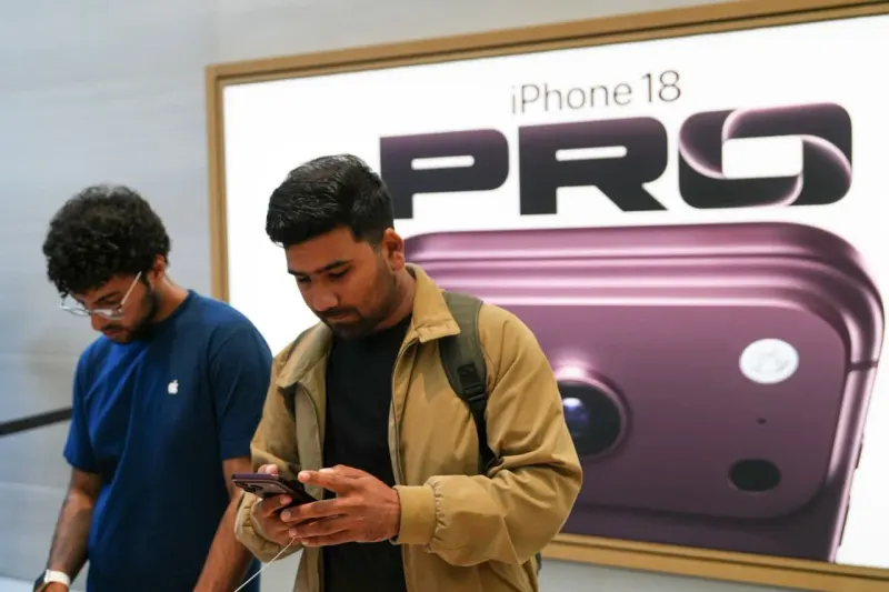 Two smartphone-shaped balloons deflate together, symbolizing lower component orders for Apple’s premium iPhone 18 models.