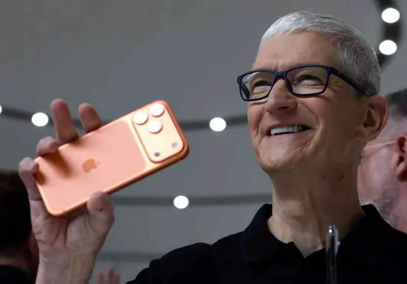 A red apple forms an umbrella shielding investments from a storm of AI chips and coins.