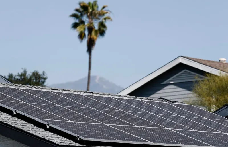 A solar-panel boomerang punctures a wallet, symbolizing renewable mandates raising household electricity costs.