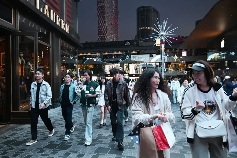 A coin-shaped compass is secretly pulled across China, symbolizing concerns about biased AI travel guidance.