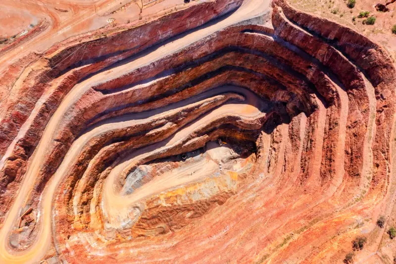 A towering copper wave stands on solid bedrock as three symbolic cracks threaten its base.