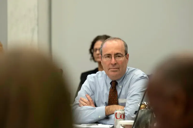 Floating price tags resist a powerful magnet, symbolizing the Fed’s effort to curb corporate price increases.