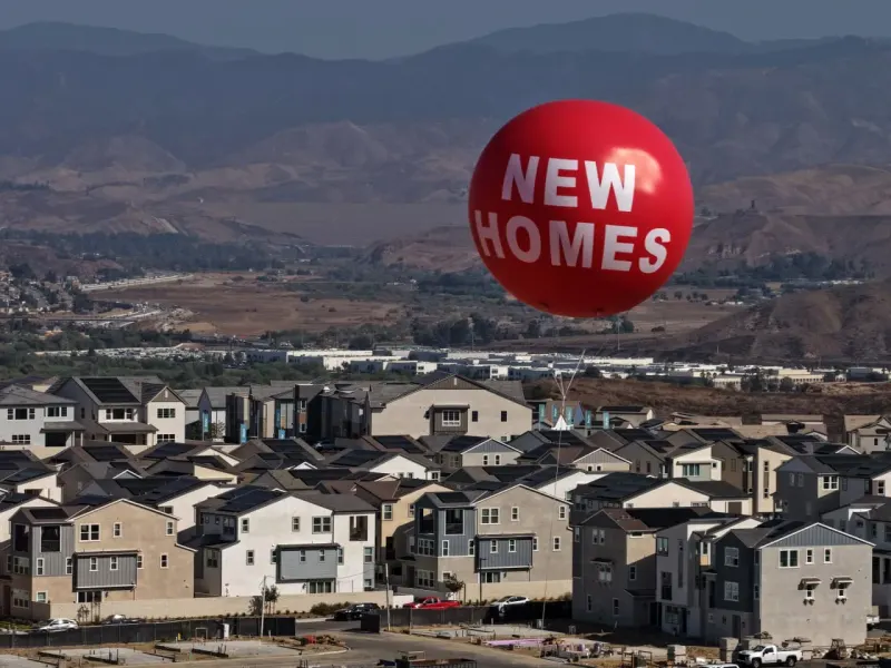 A compass turns from a glowing chip toward rising houses, symbolizing Hench’s shift from AI to housing bets.