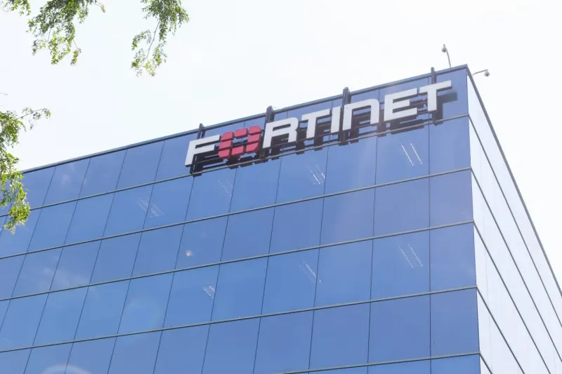 A digital fortress tilts on a shrinking foundation as nearby shields lean, symbolizing Fortinet’s segment slowdown.