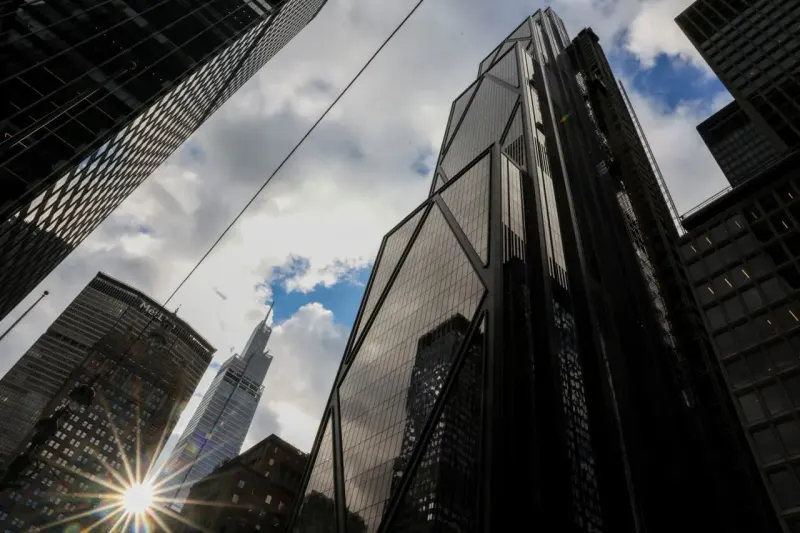 A bronze bull remains steady as falling bond weights bend, but do not break, its platform.