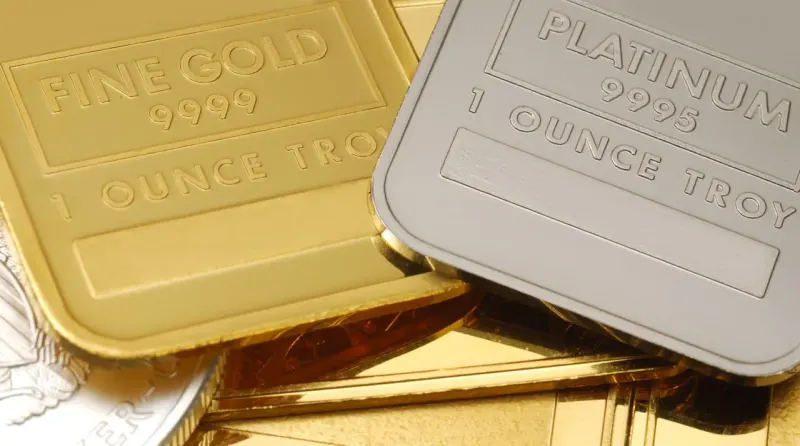Gold and platinum weights cast a stock chart shadow, suggesting their ratio may guide market direction.