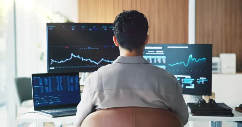A bull crosses a narrow rising bridge through swirling rate arrows toward a shining market peak.