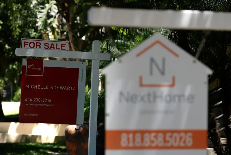 A house on a flat track approaching a steep drop symbolizes Goldman Sachs’ worsening housing outlook.