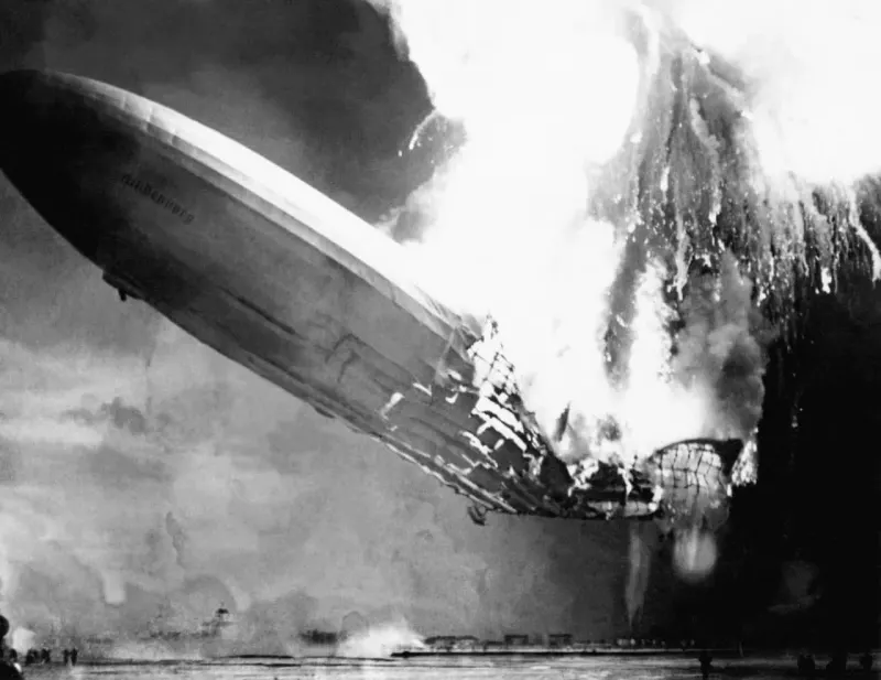 A red zeppelin-shaped warning light hovers over a fragile market arrow, symbolizing an uncertain crash signal.