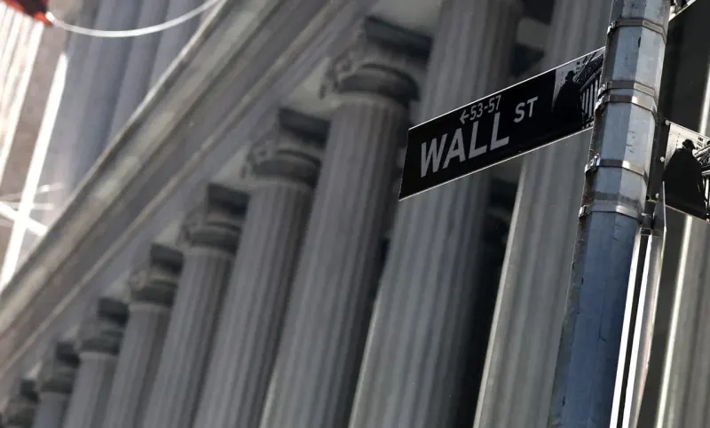A three-pronged compass points toward circuit chips and a bank column as market storm clouds recede.
