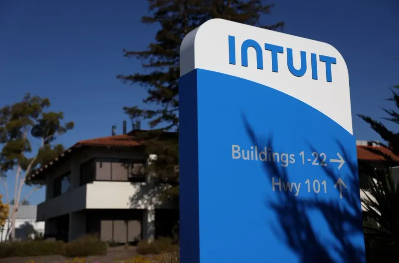 A tax calculator tilts on a falling price tag as coins roll away, symbolizing TurboTax customer losses and Intuit's decline.