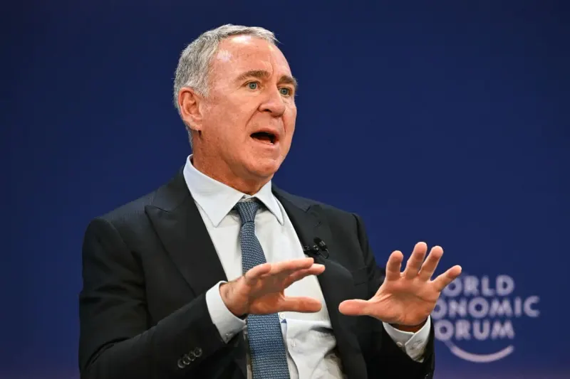A silicon chip floats inside a fragile bubble, symbolizing Ken Griffin’s warning about AI stock valuations.