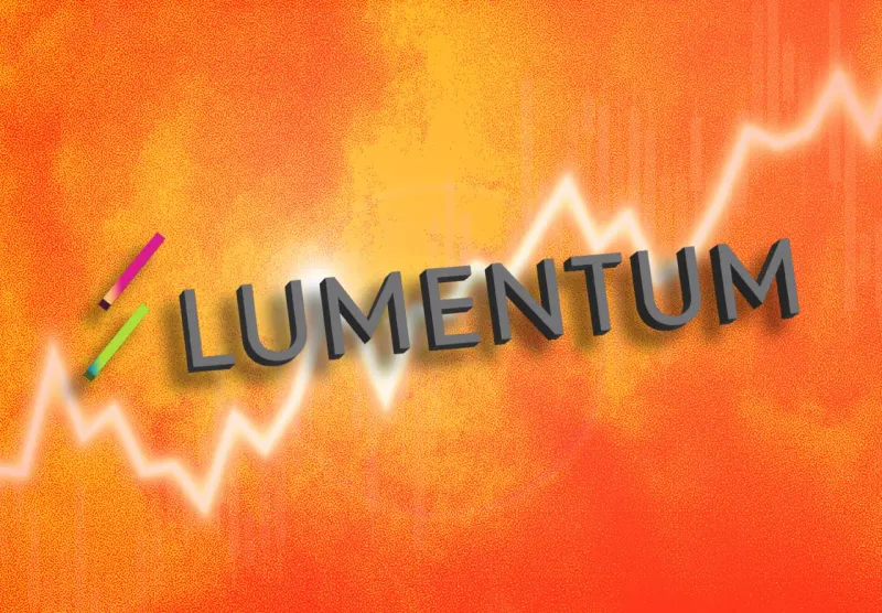 A glowing optical fiber bends toward a magnet, symbolizing Marvell’s possible acquisition of Lumentum.