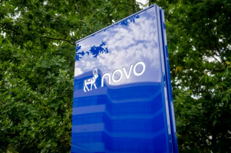 Two golden keys break through a frozen wall, symbolizing Novo Nordisk’s licensing deals after a cold investor response.
