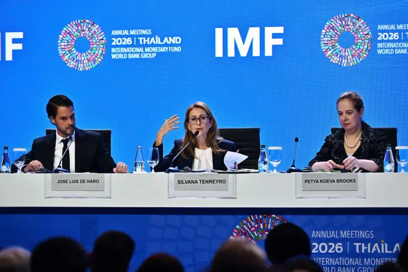A globe compressed into one tangled chart line reflects an IMF graphic said to summarize the 2026 world economy.
