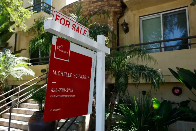 A house-shaped anchor pulls a purchase contract underwater as rising rates weaken home sales.