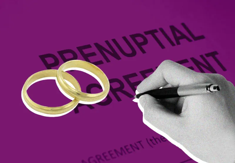 Two wedding rings shelter beneath an asset-patterned umbrella, showing prenups can protect more than extreme wealth.