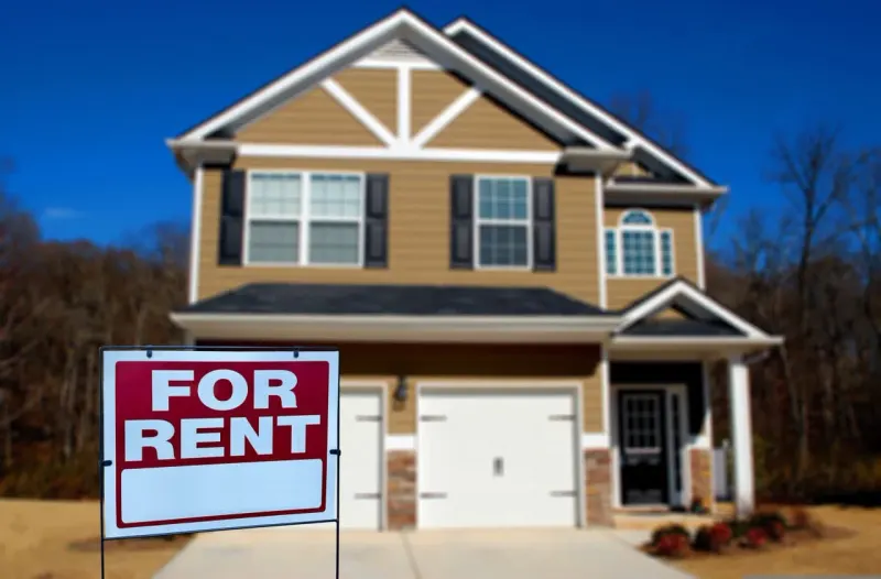 A rental house becomes a millstone weighing on a retirement nest egg, symbolizing the burden of landlord work.