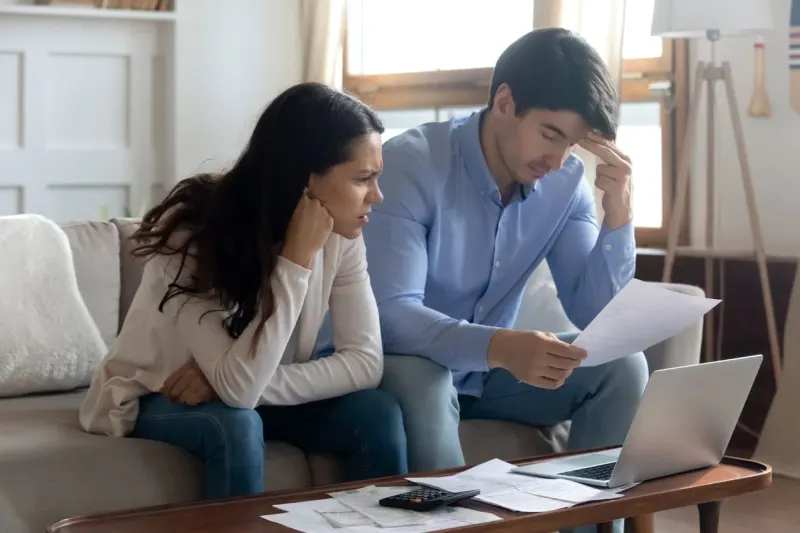 A golden house anchor weighs down a scale as a rental key rises, symbolizing renting's claimed financial advantage.