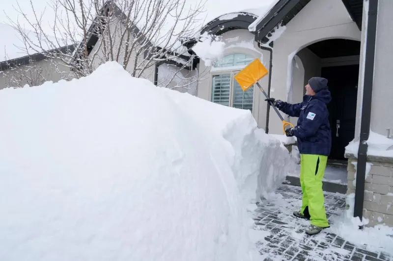 A household wallet frozen inside rising ice symbolizes climbing utility costs before winter.