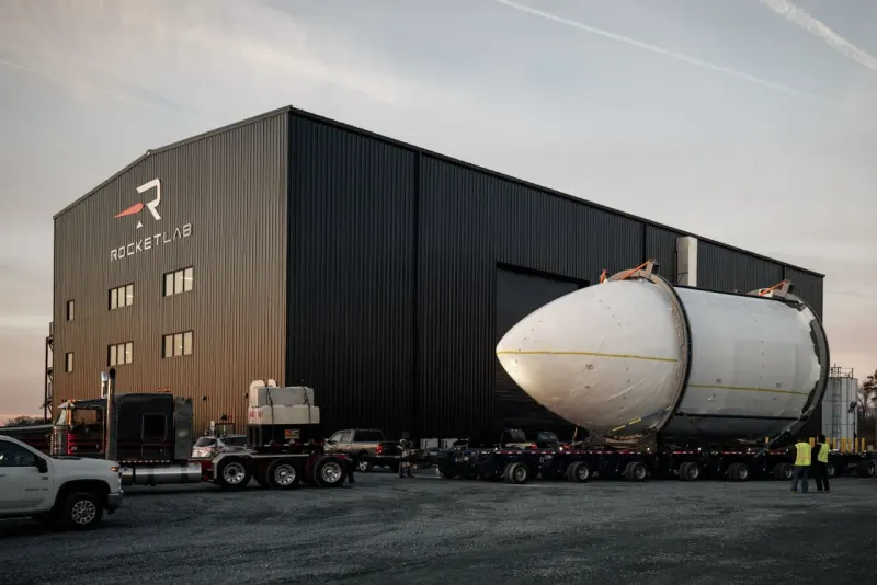 A rocket trapped inside an hourglass symbolizes Neutron’s launch delay beyond 2026.