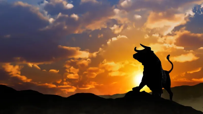 A golden bull shaped hill quietly crests before descending into a red valley, symbolizing correction risk.