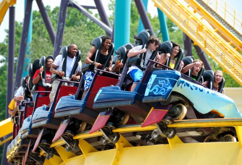 A roller-coaster car plunges down a stock-chart track, symbolizing Six Flags shares nearing a yearly low.