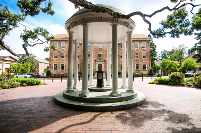 An academic tower balances on one giant rocket-shaped pillar as smaller portfolio supports fall away.
