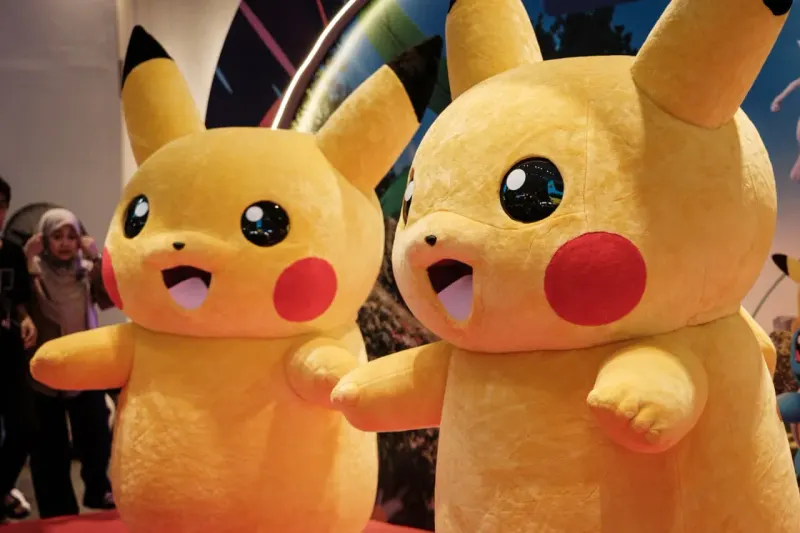 A 30-candle trading-card cake vanishes into a red basket, symbolizing Target’s Pokémon sellouts.
