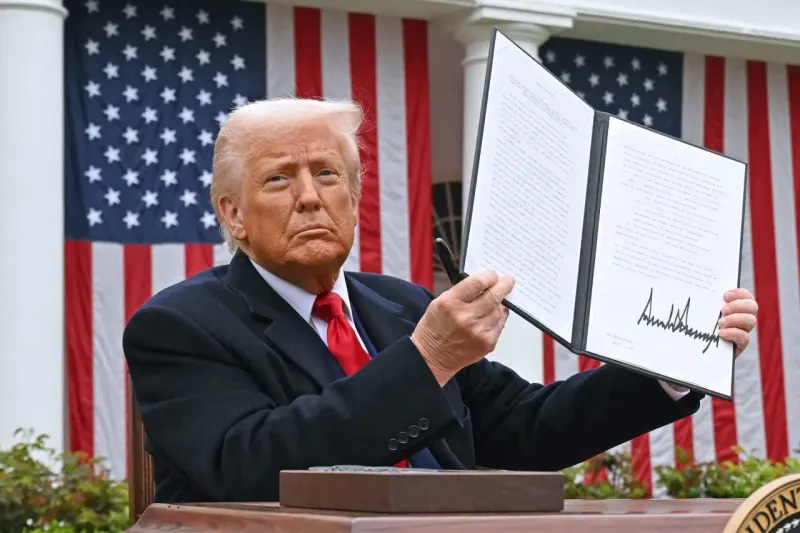 Coins from a cracked tariff wall tip a scale toward a briefcase and away from a household shopping basket.