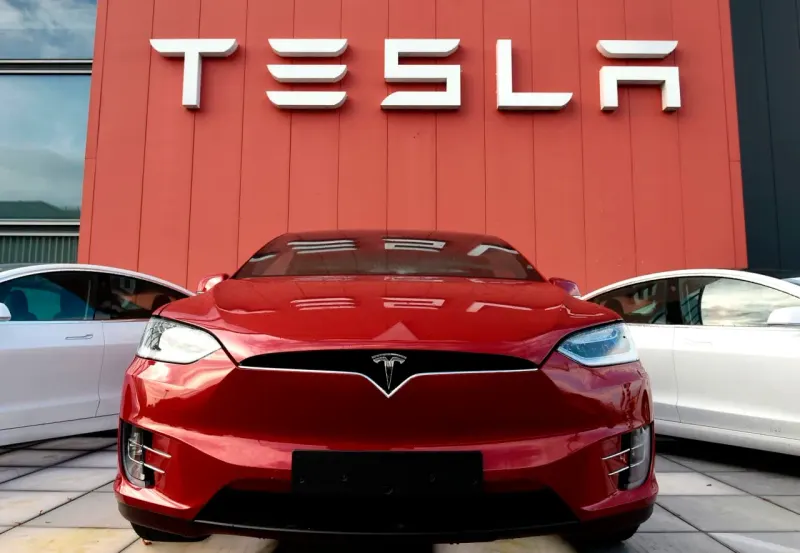 An electric car clears a forecast hurdle while its shadow falls short of the prior year's sales marker.