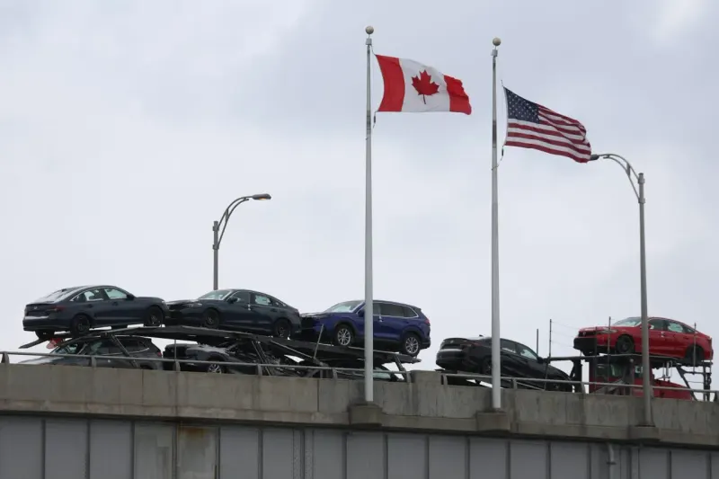 A maple leaf sits beneath a suspended portcullis, symbolizing delayed tariffs on Canadian goods.