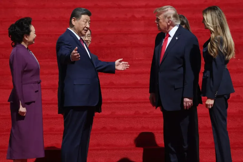 A trade barrier opens for a doll and firework but is jammed by rare-earth crystals.