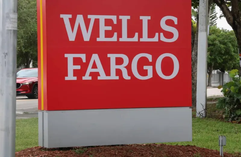 A market staircase approaches a suddenly lowered bullseye, symbolizing Wells Fargo’s reduced S&P 500 target.